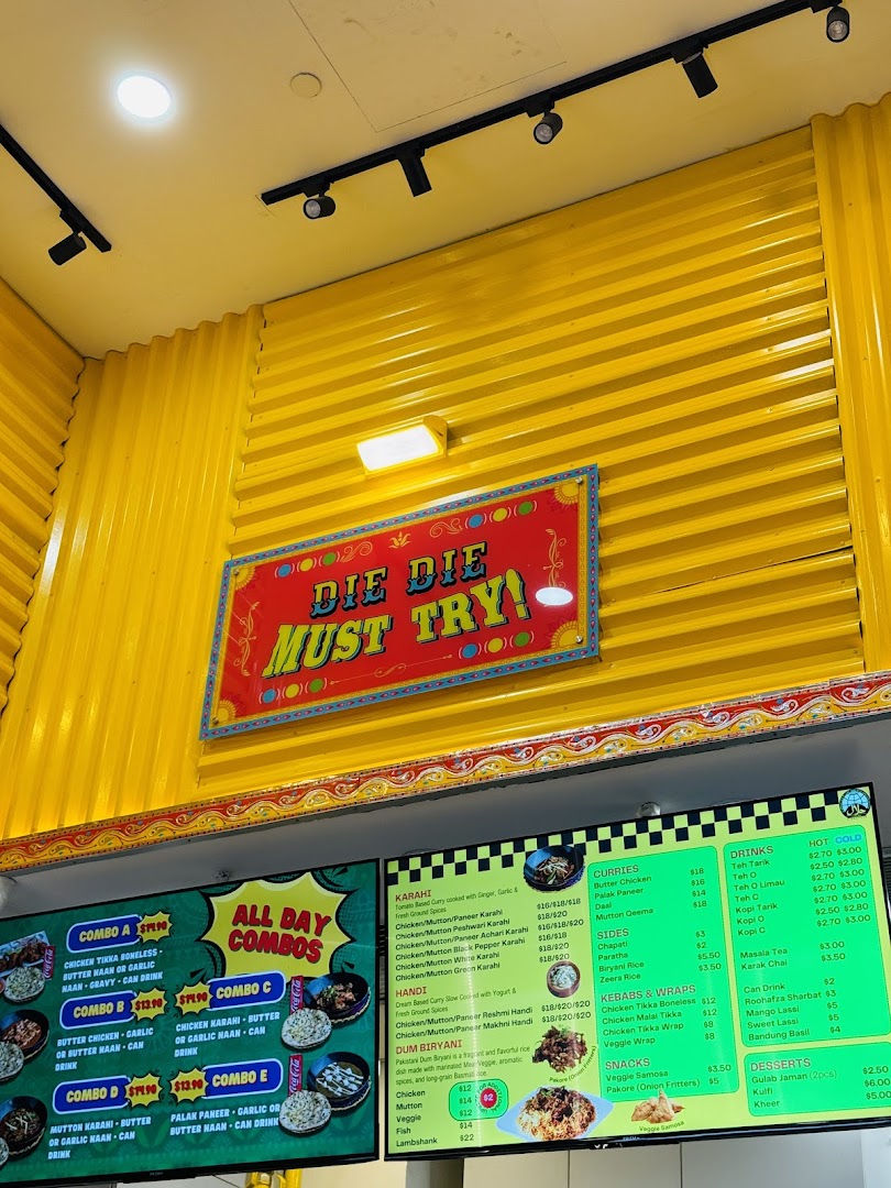 Digital menus displaying food and prices on a bright yellow wall.