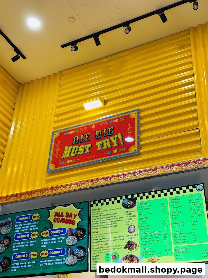 Digital menus displaying food and prices on a bright yellow wall.