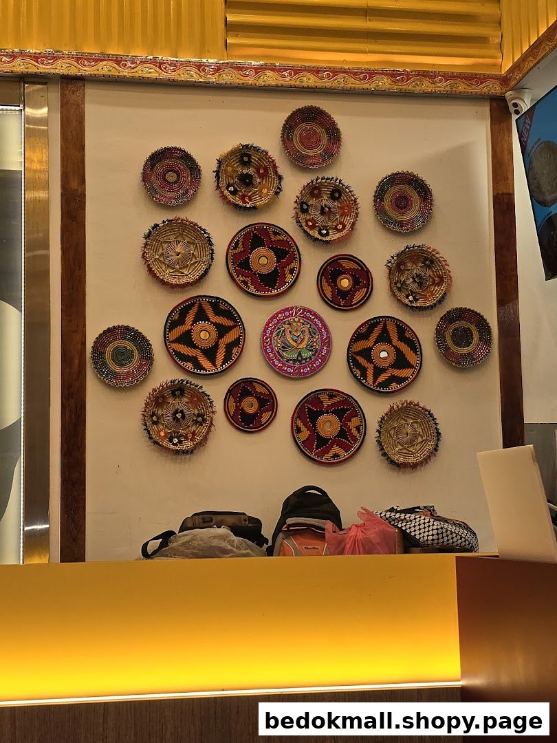 Interior wall decorated with colorful plates above a counter with bags.