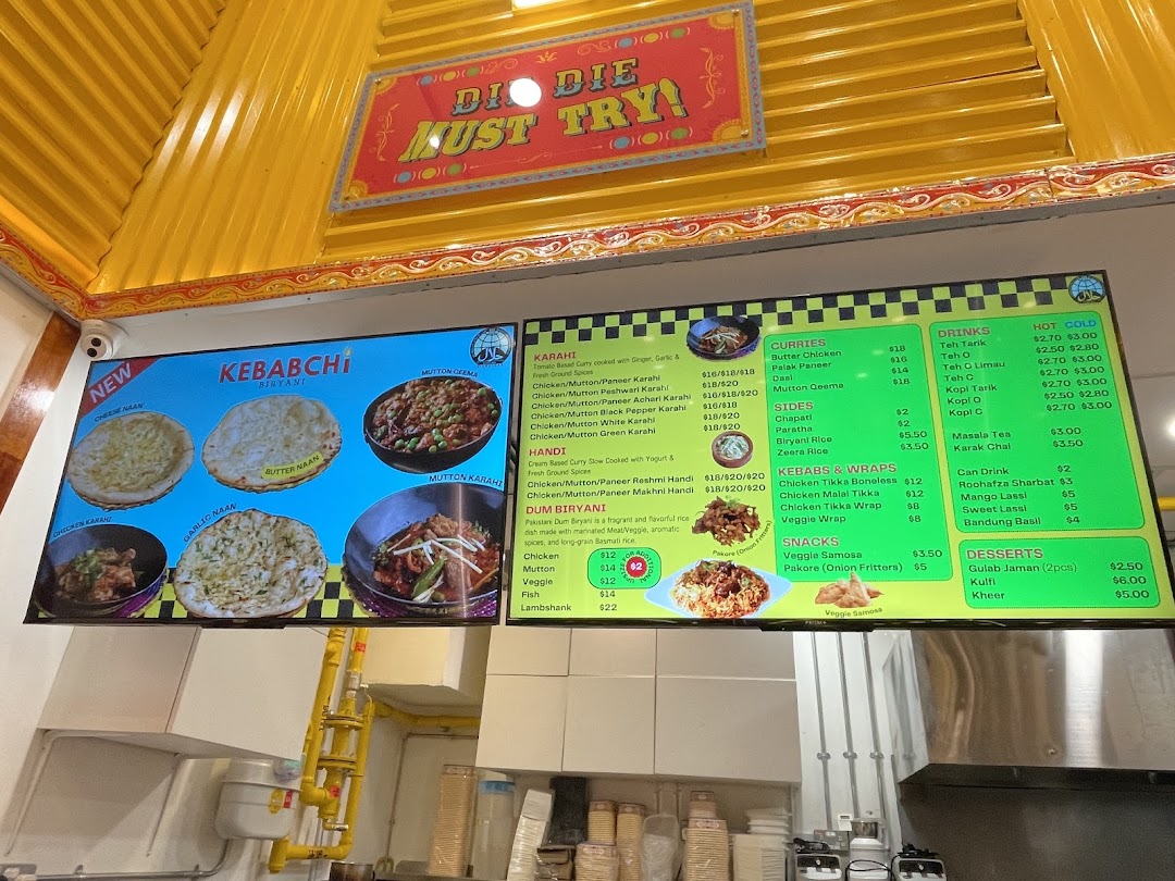A large digital menu board displaying various food items and prices.