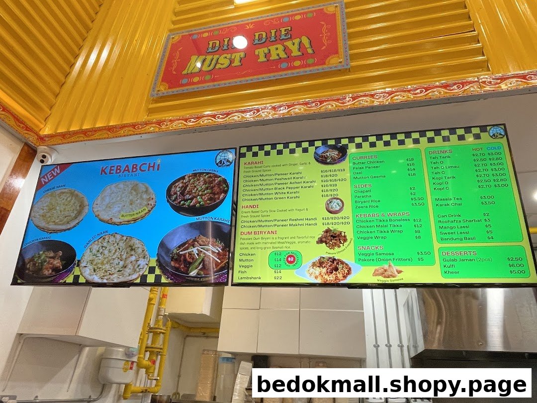 A large digital menu board displaying various food items and prices.