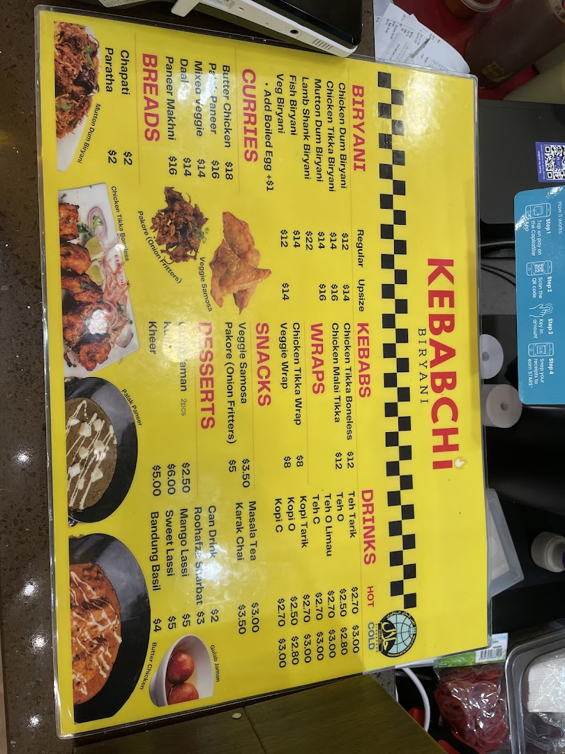 A yellow menu board displaying food items and prices for Kebabchi Biryani.