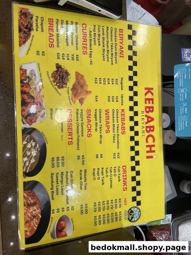 A yellow menu board displaying food items and prices for Kebabchi Biryani.