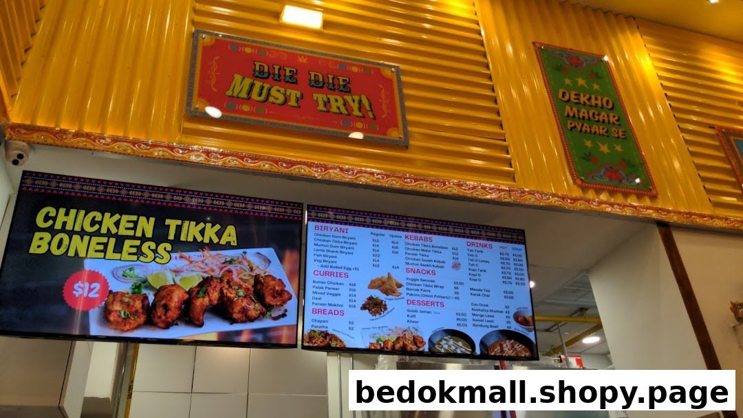Digital menu boards displaying various food items and prices inside a shop.