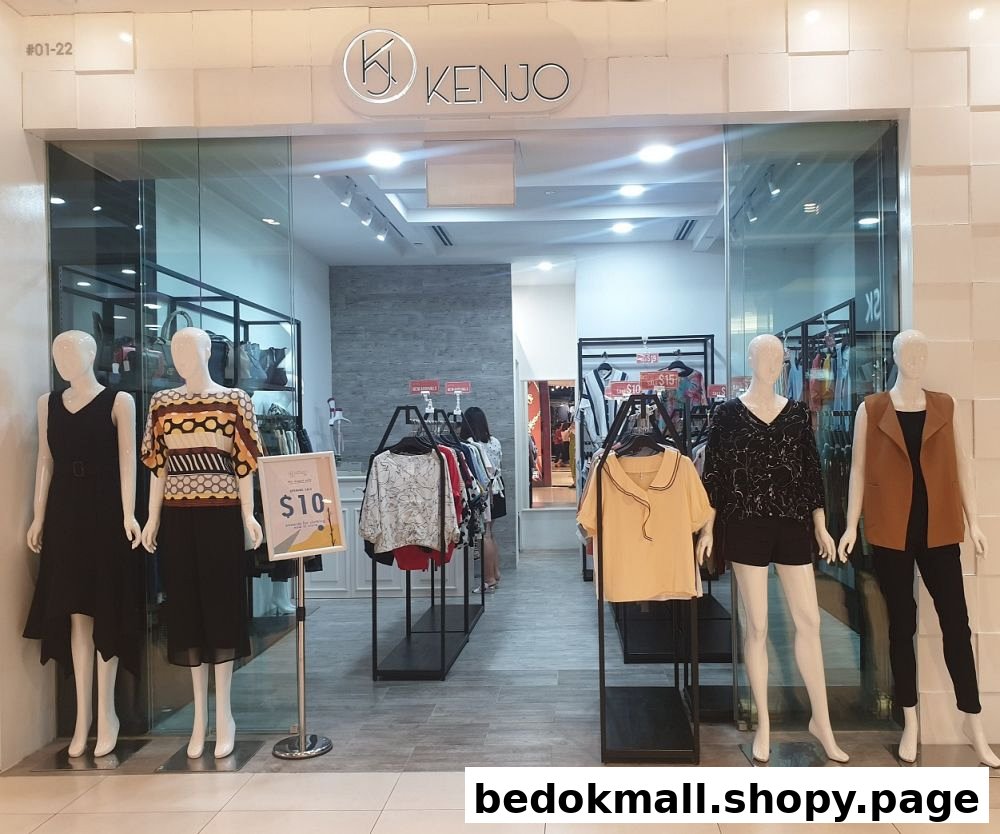 Shop entrance with mannequins displaying clothes and a visible shop name.