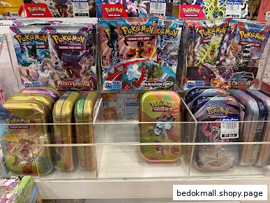 Display of Pokemon Trading Card Game booster packs and tins on shelves.