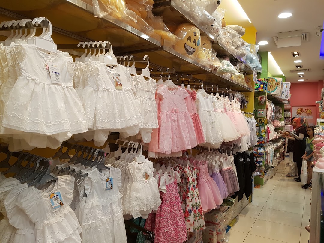 Interior view of a children's clothing and toy shop with customers.