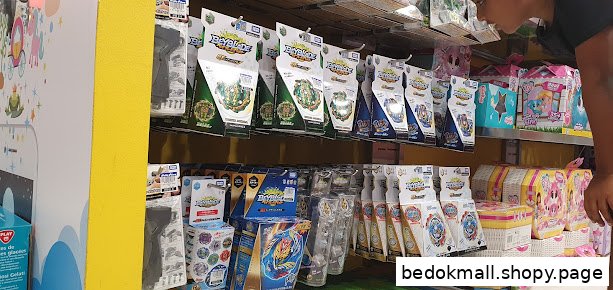 Interior view of a toy shop with shelves of Beyblades and other products.