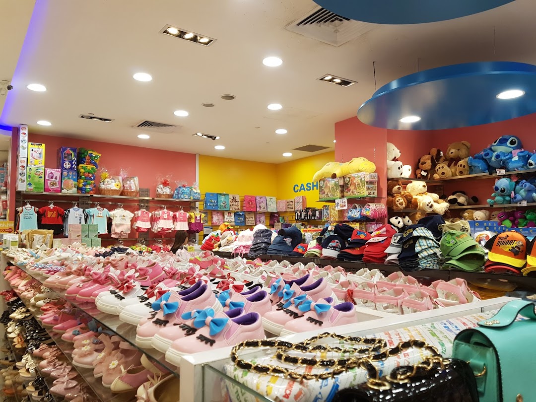Interior view of a children's store displaying shoes, clothing, and toys.