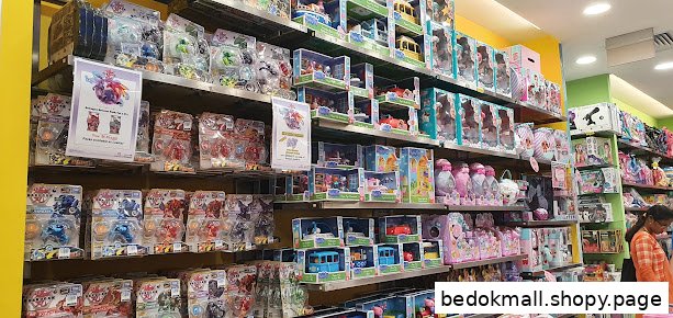 Interior view of a toy store with shelves full of various products and a customer.