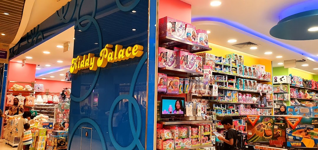Interior of a Kiddy Palace toy store showing products and shoppers.