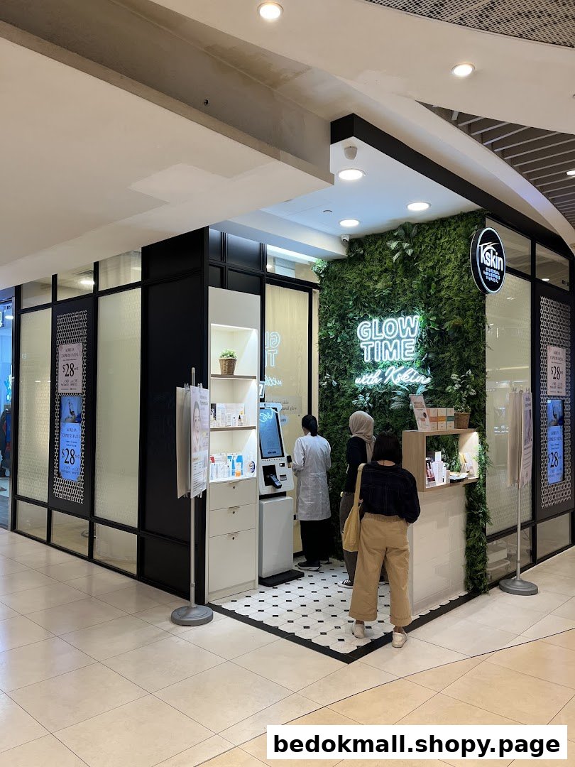 Shop front with a green wall, neon sign, and people at the counter.