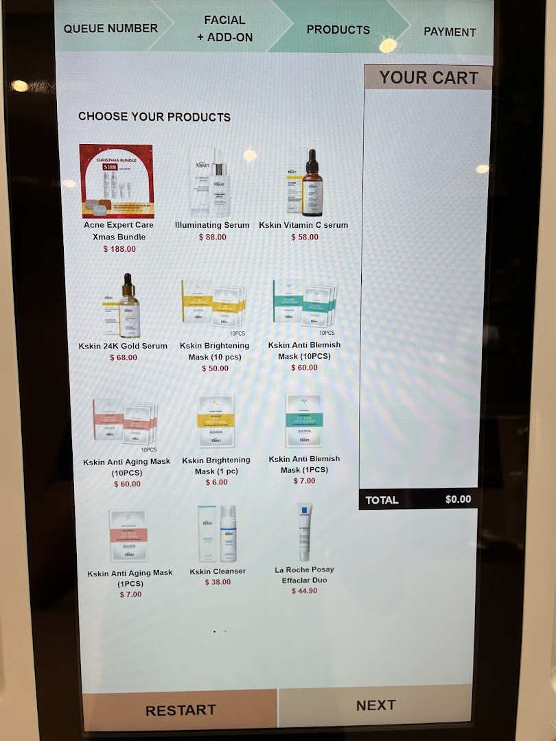 Digital screen displaying skincare products, prices, and a shopping cart interface.
