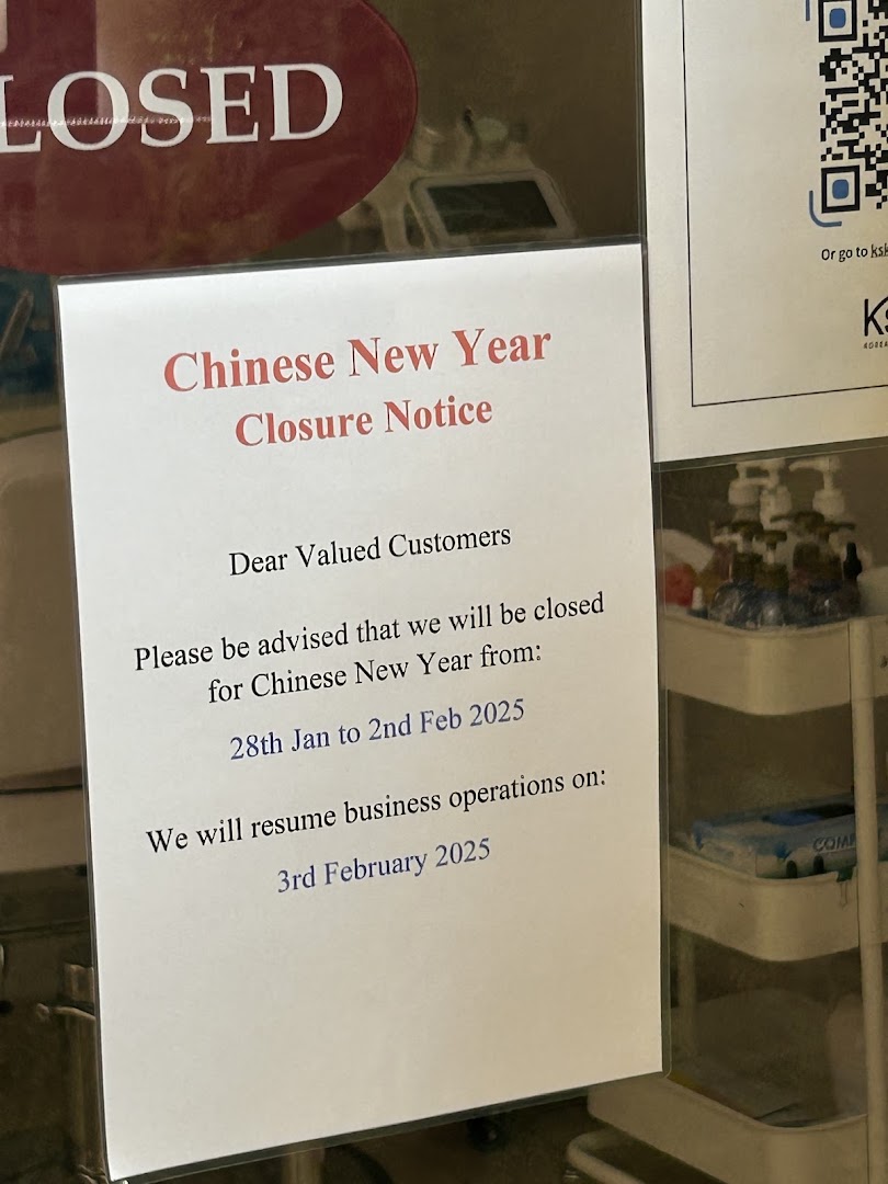 A Chinese New Year closure notice and 'CLOSED' sign on a shop's front.