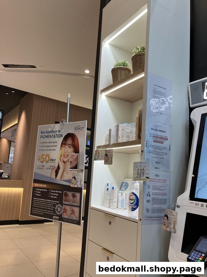 Interior view of a shop with product display, promotional sign, and payment kiosk.