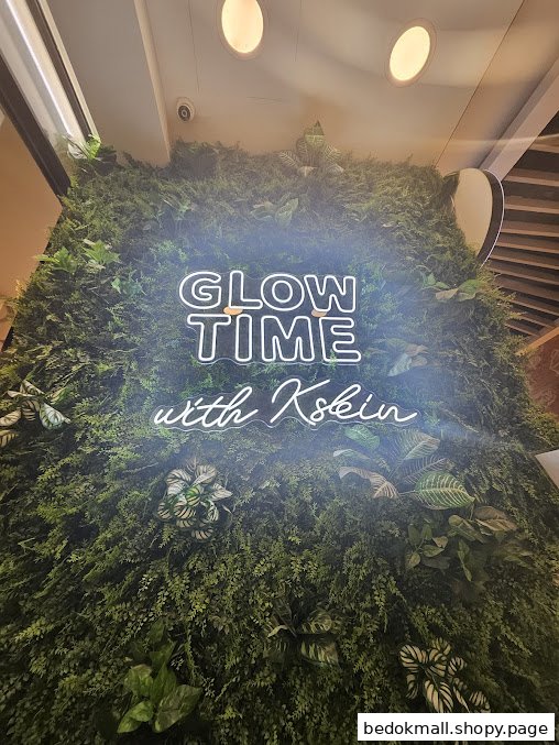 Green wall with a neon sign saying 'GLOW TIME with Kskin'.