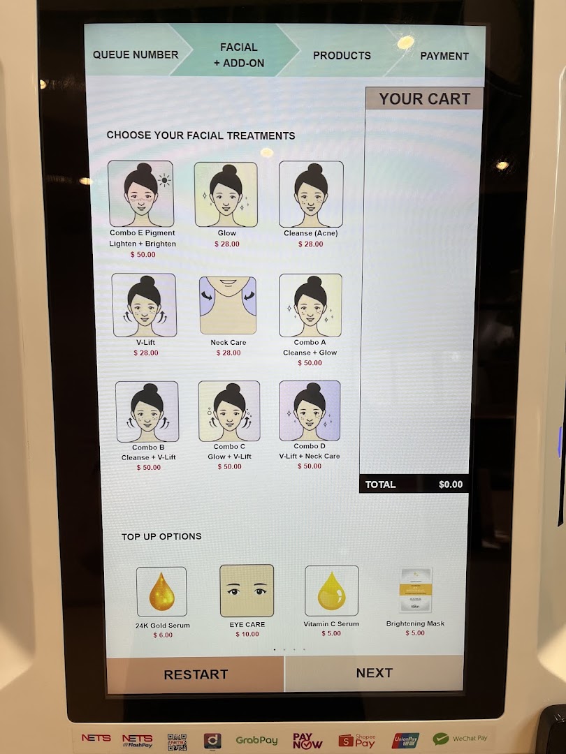 Digital screen displaying facial treatments and prices for selection.