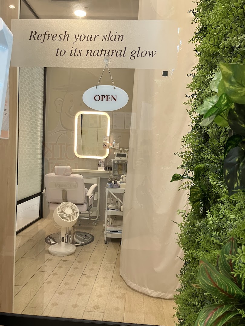 View into a facial shop with a treatment chair and equipment.