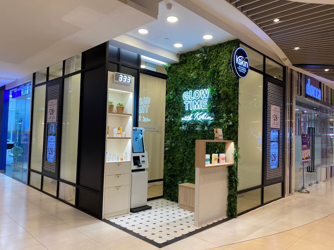 Exterior view of Kskin Korean Express Facial shop with green wall and neon sign.