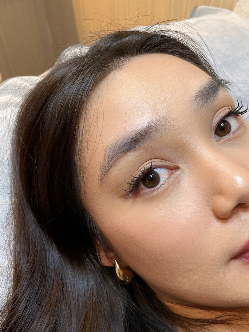 Close-up of a person's face showing groomed eyebrows and eyelashes.