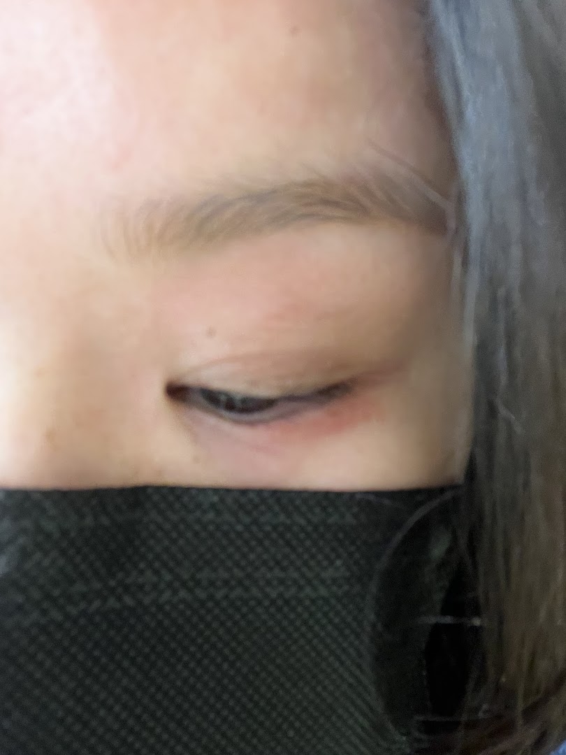 Close-up of a person's eye and a black face mask.