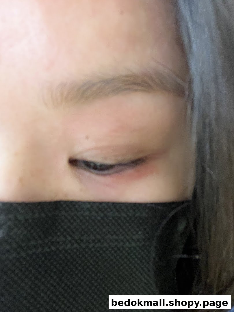 Close-up of a person's eye and a black face mask.