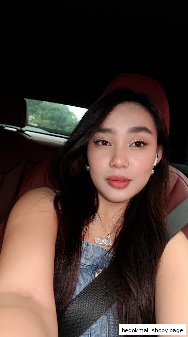 A woman taking a selfie inside a car.