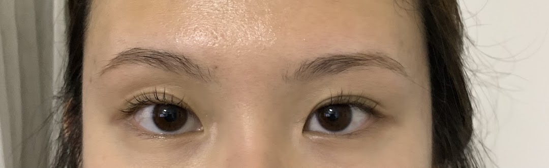 Close-up of a person's eyes and forehead, showing eyelashes and eyebrows.