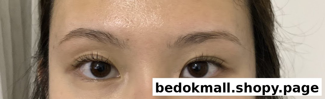 Close-up of a person's eyes and forehead, showing eyelashes and eyebrows.