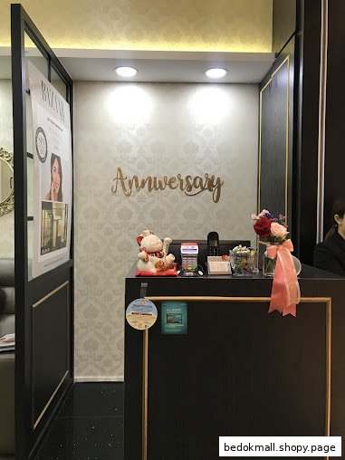 Interior view of a reception desk with a Lucky Cat and flowers.