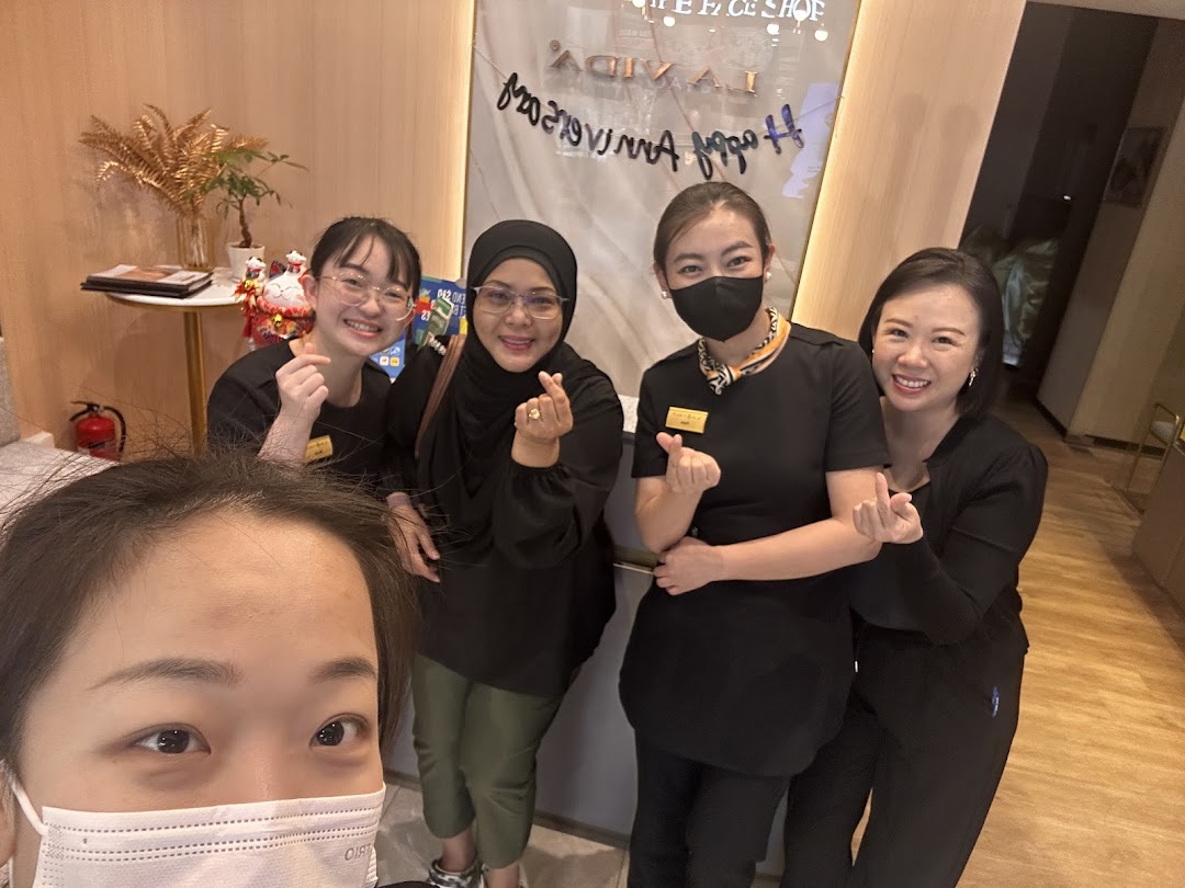 Five people, likely staff, posing inside a shop.