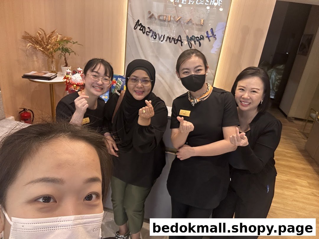 Five people, likely staff, posing inside a shop.