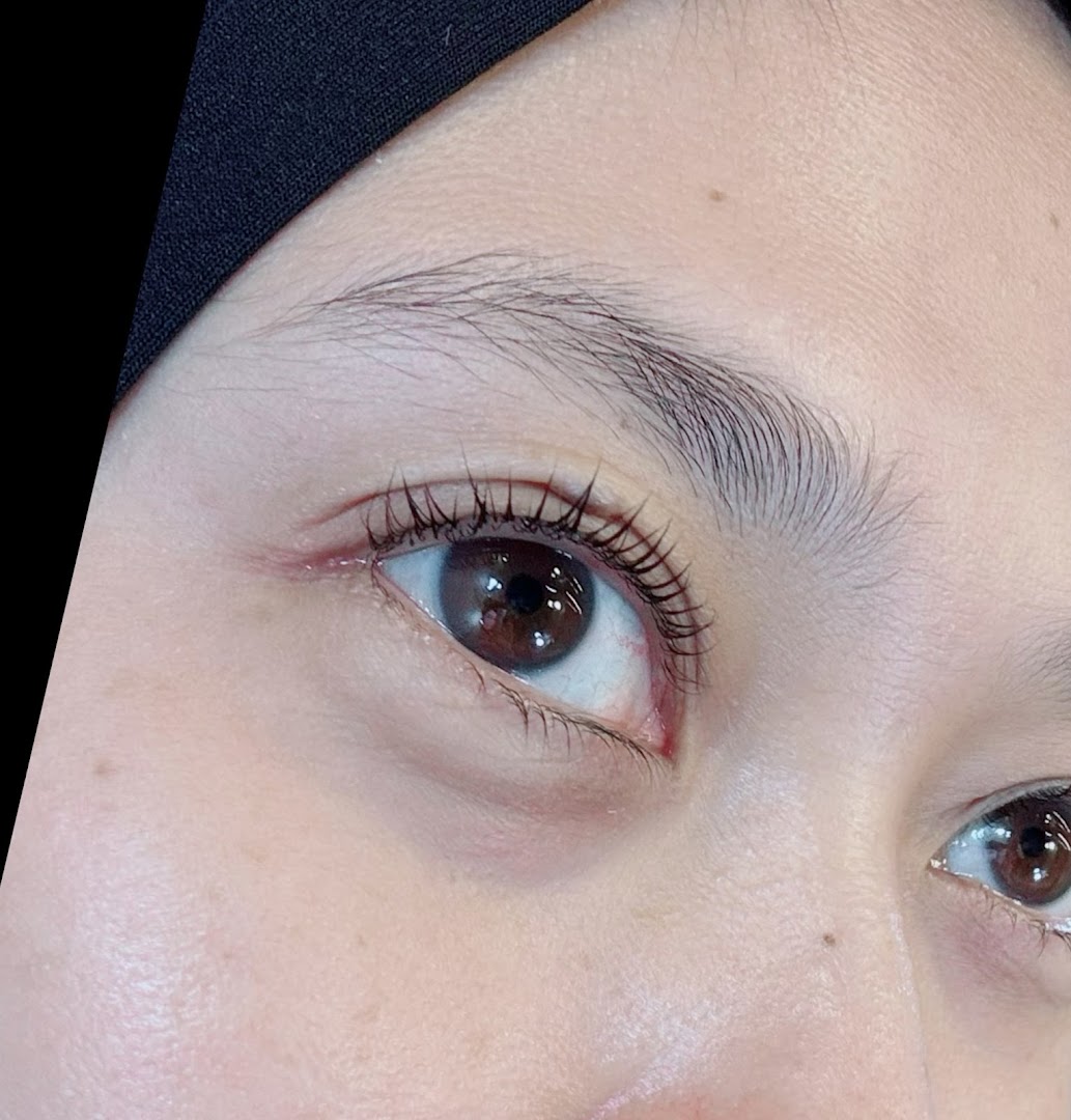Close-up of a person's eye showing eyelashes, likely after a beauty treatment.