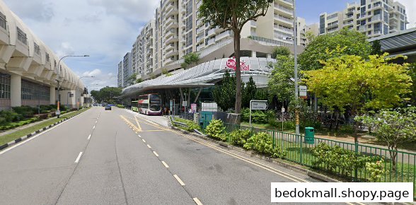 Street view of Bedok Mall exterior with a bus stop and double-decker bus.