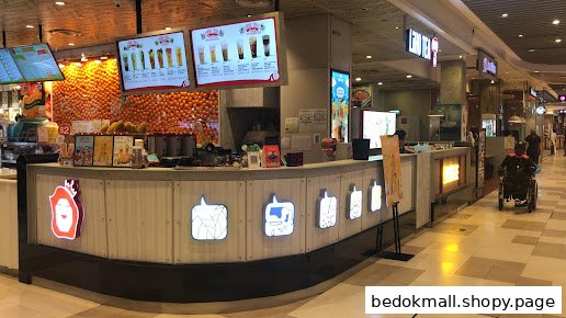 Interior view of a bubble tea shop counter with menu boards and orange decor.