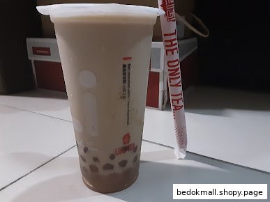 A close-up of a bubble tea drink with a straw.