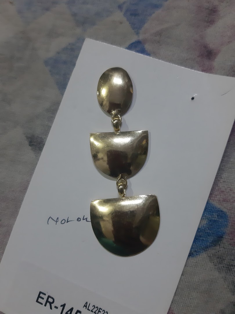 A gold-colored dangle earring on a white product card.