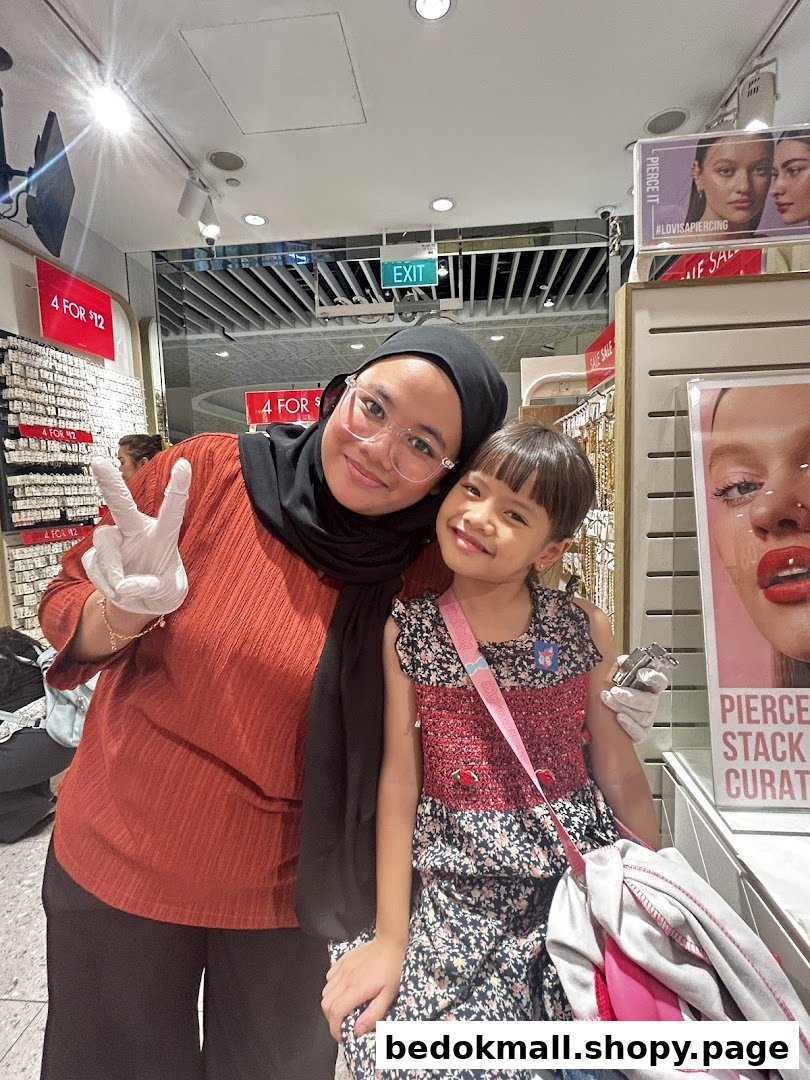 Two people posing inside a Lovisa store with merchandise displays and promotional signs.