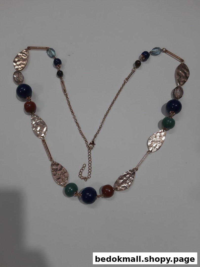 A long necklace with colorful beads and hammered metal leaf accents.