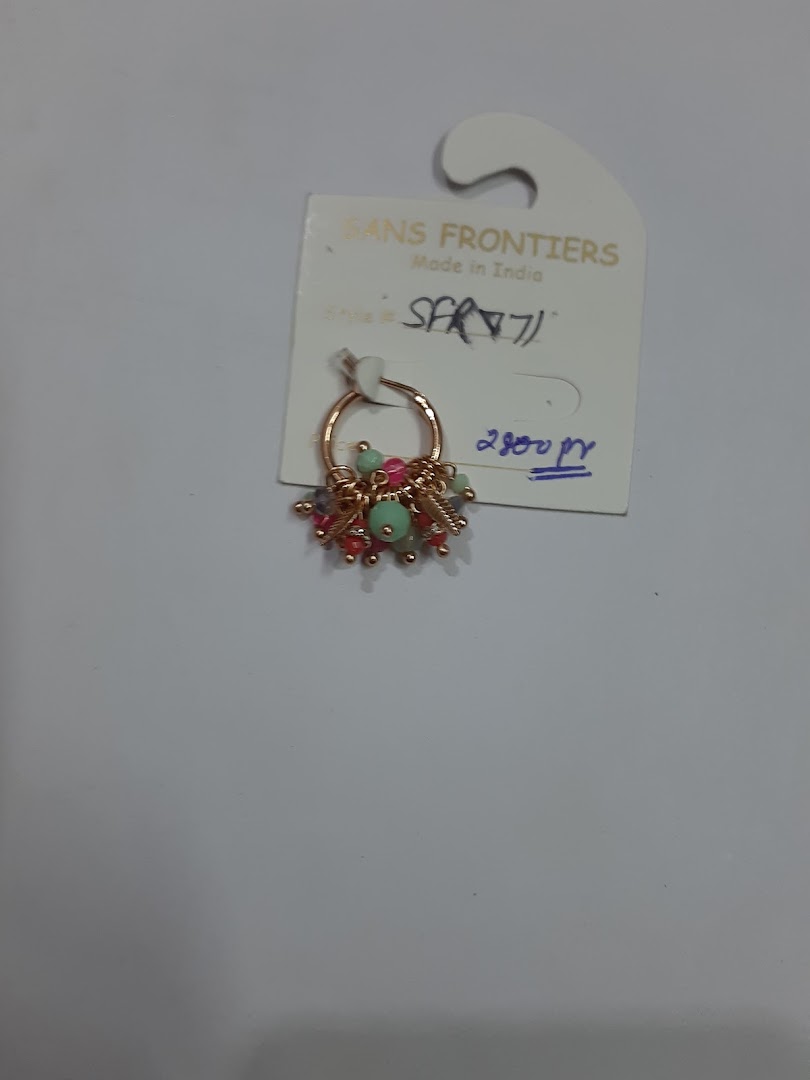 A beaded hoop earring on a product tag with price details.