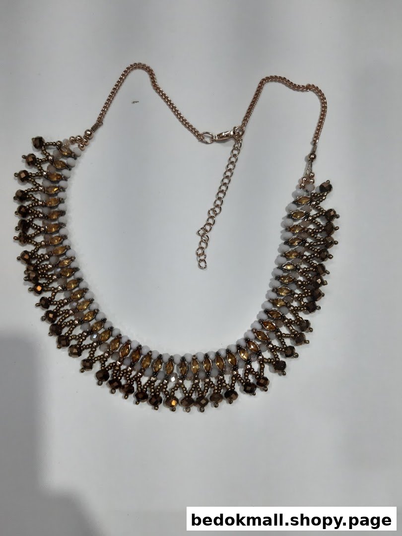 Beaded necklace with chain on a white background.