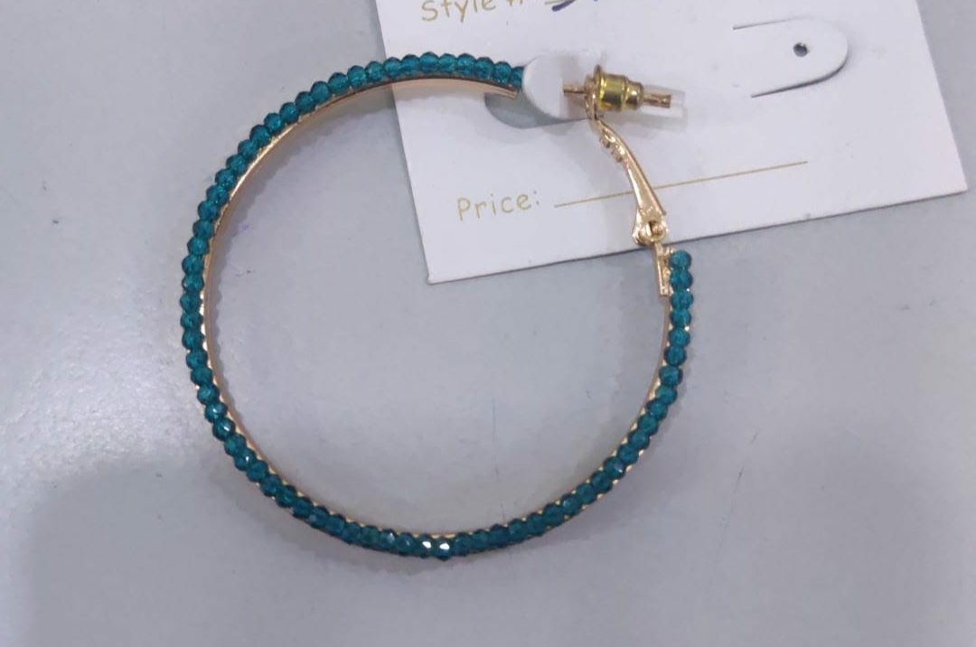Teal beaded hoop earring on a white price tag.
