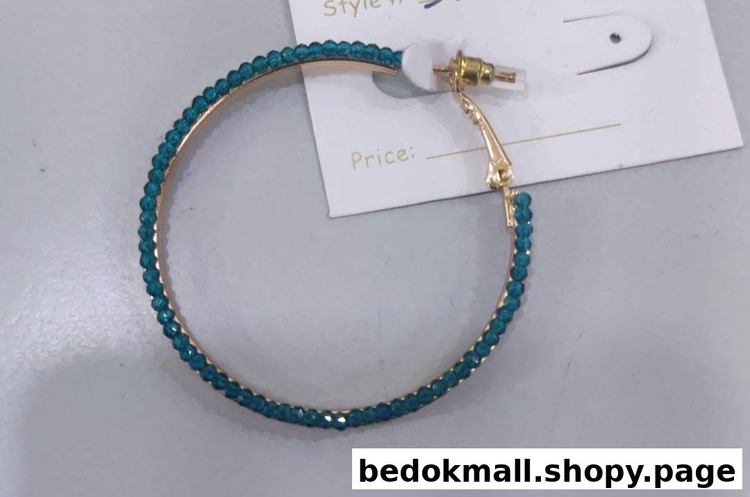 Teal beaded hoop earring on a white price tag.