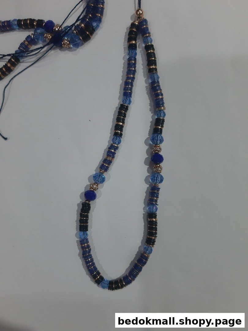 Blue and black beaded necklace with gold accents on a light background.
