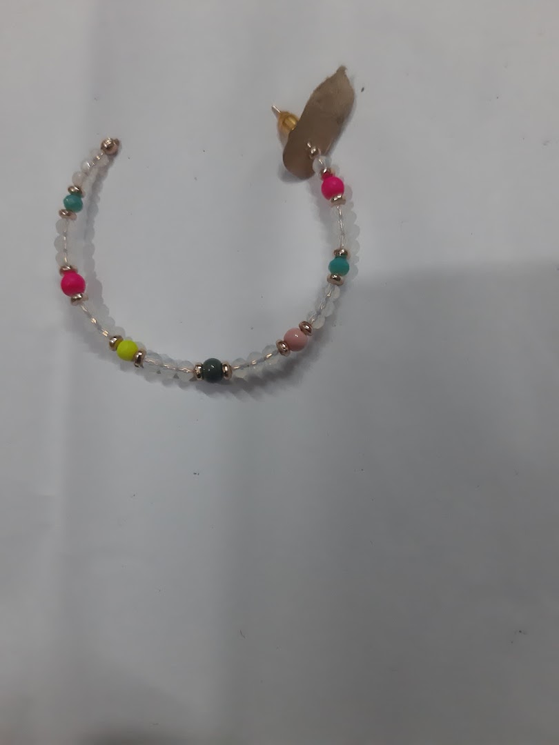 A single beaded hoop earring with colorful beads on a white surface.