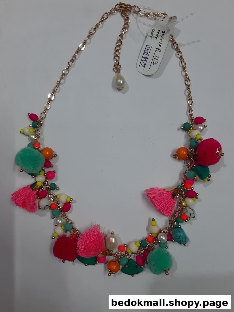 Colorful necklace with beads, tassels, and pom-poms on a white background.