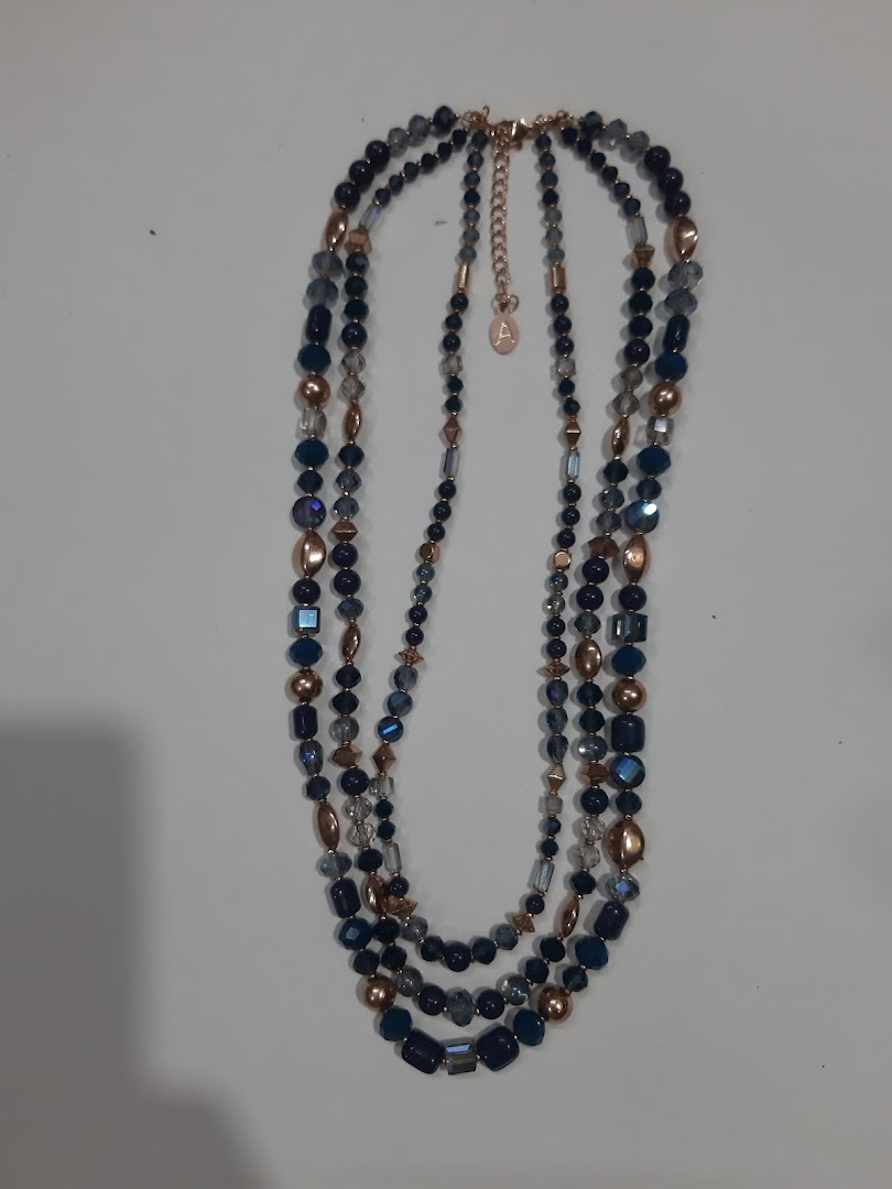 Multi-strand beaded necklace with blue and gold beads on a white background.