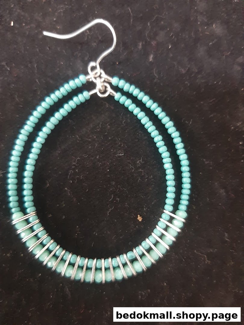 Close-up of a turquoise beaded hoop earring with silver wire.