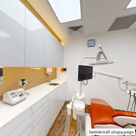 Interior of a dental clinic with a patient chair and medical equipment.