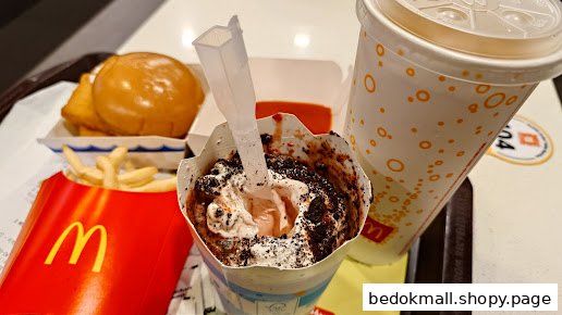 A McDonald's meal with fries, burger, drink, and a chocolate dessert on a tray.